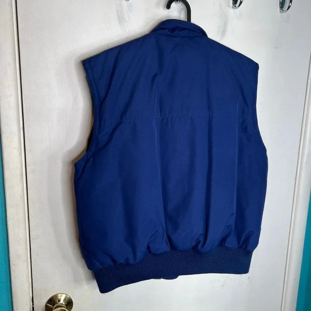 This is a vintage Eddie Bauer women's goose down-filled vest in blue 80’s strang